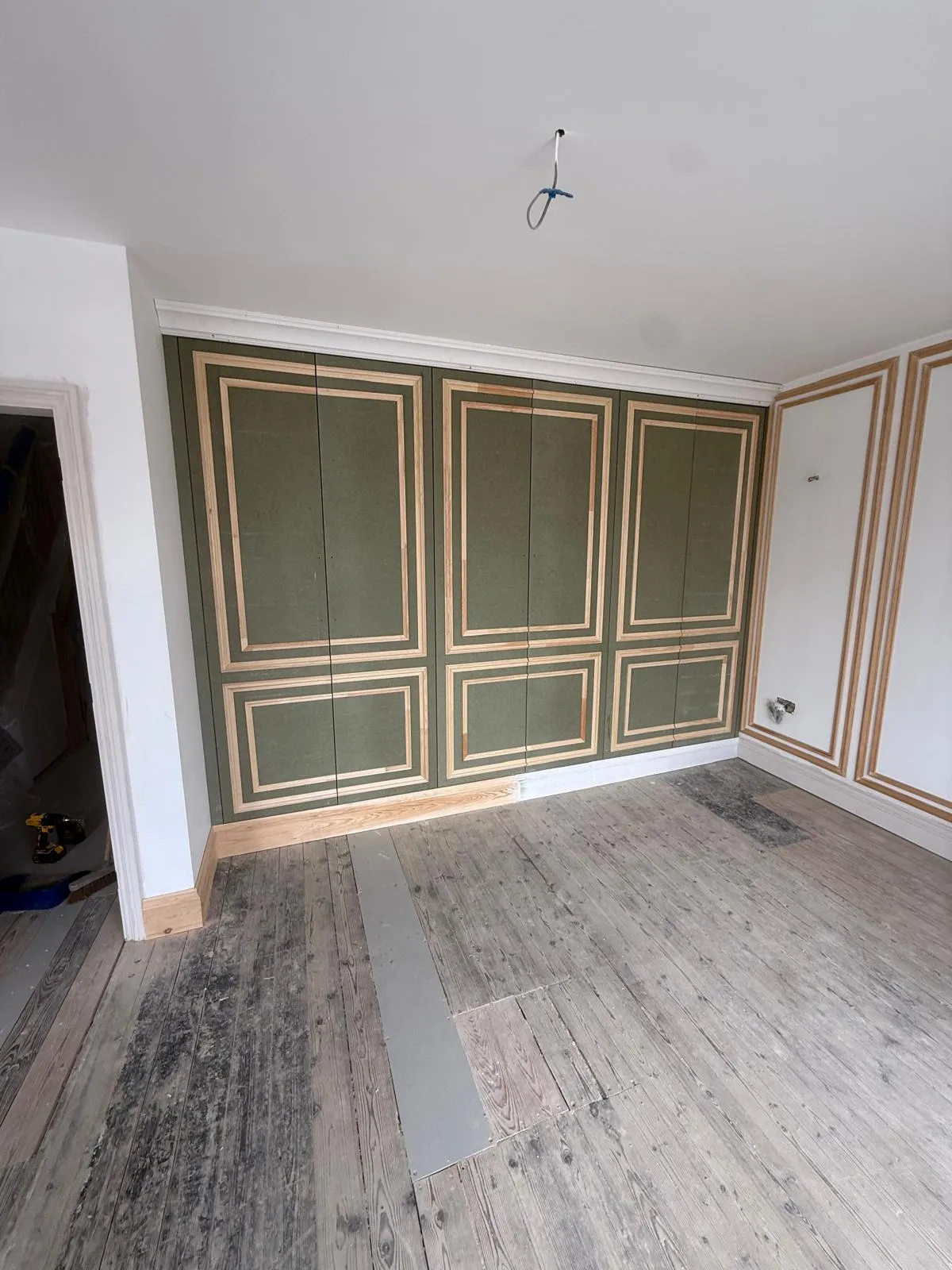 Floor-to-ceiling bespoke panelling wardrobe installation