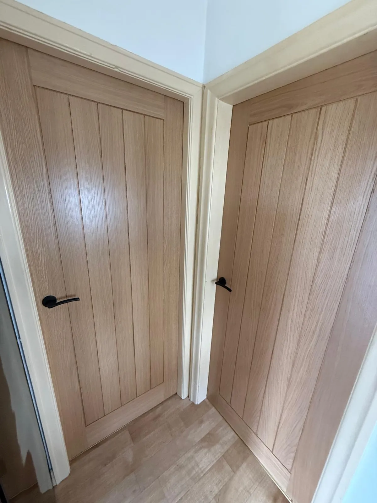 Modern brushed steel door handle and latch installation